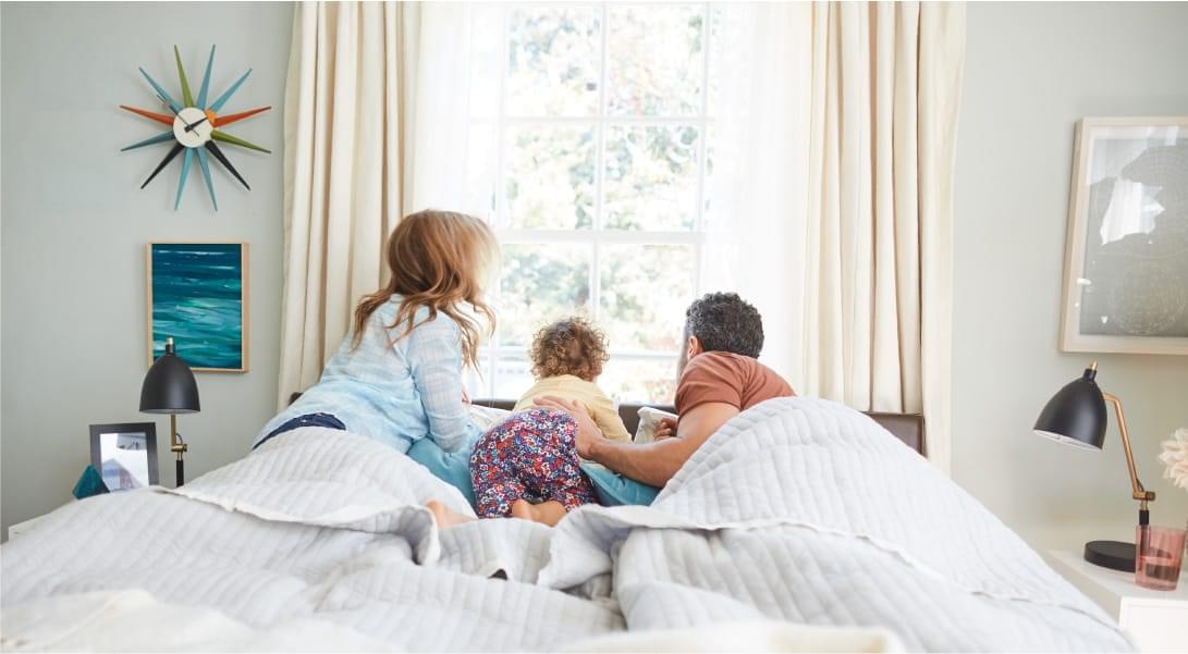 Cover Image - Family on bed looking out window